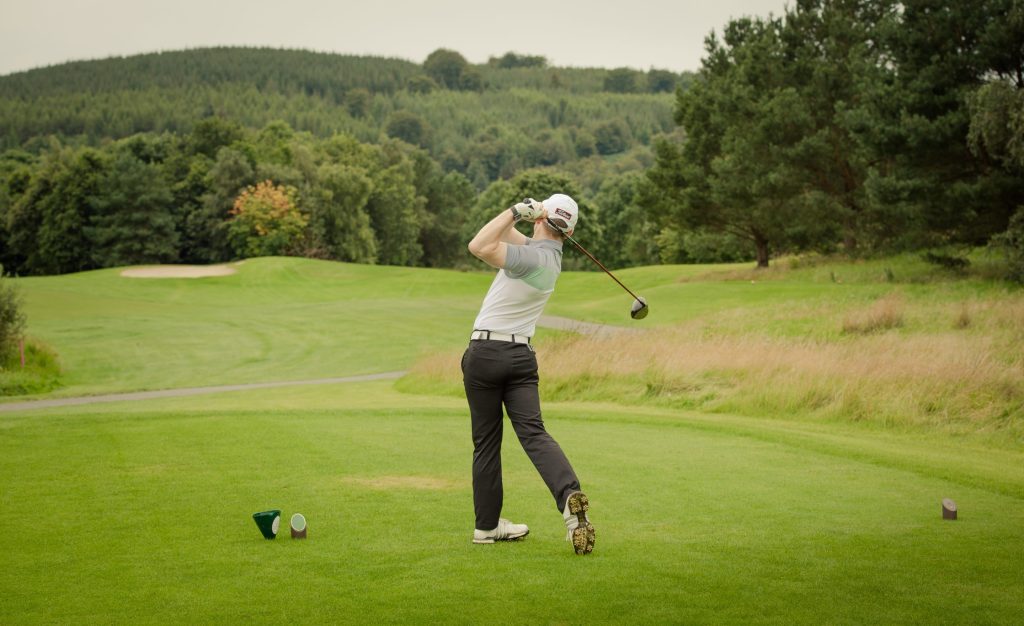 Gary Shaw LGBT Golf London UK Dublin Ireland, hitting a shot over a pond